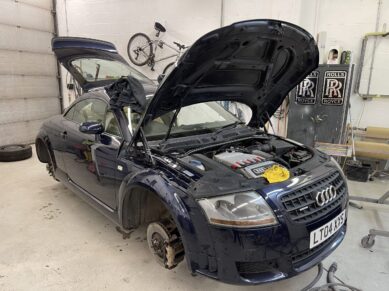 Blue Audi TT with front panels removed for repair