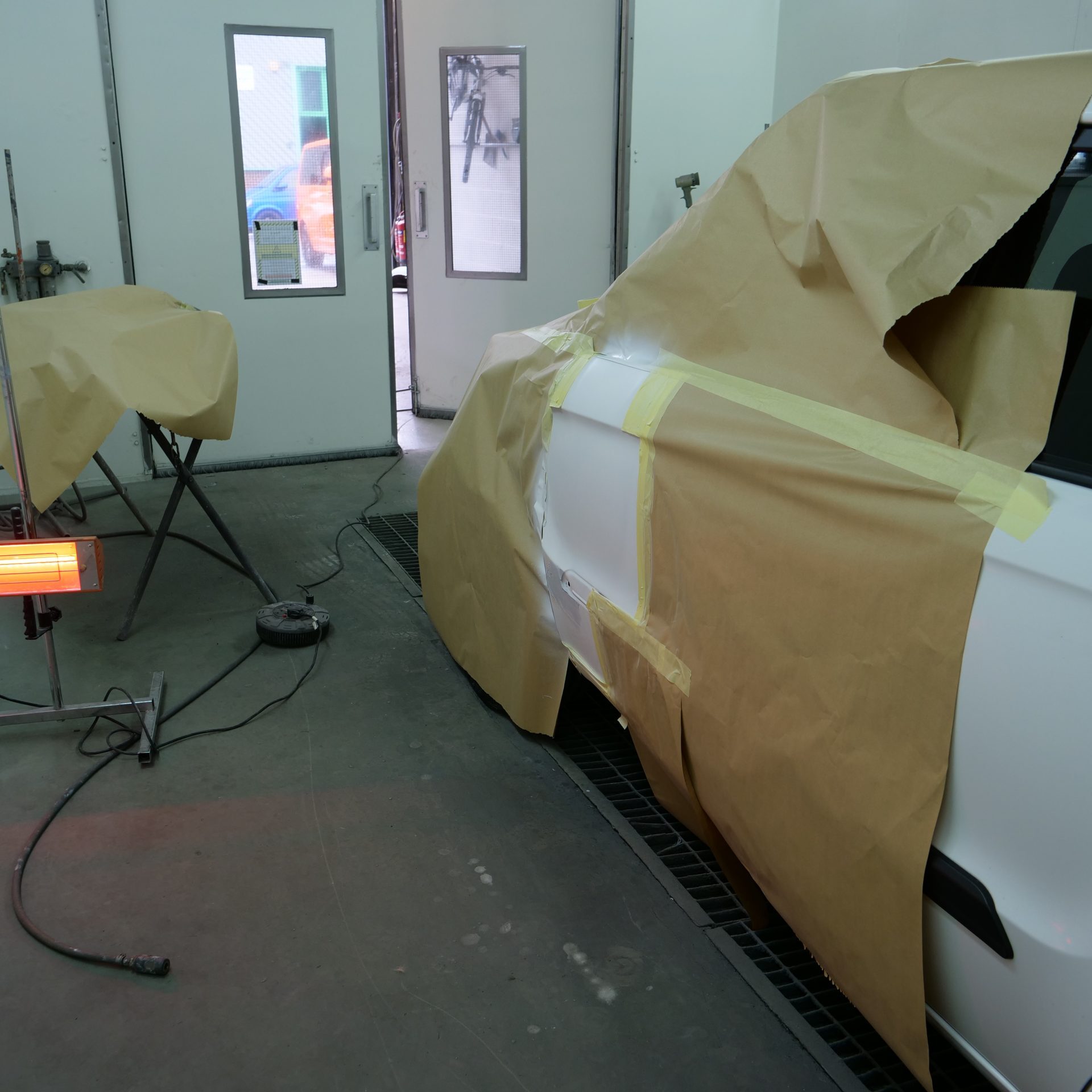 White car masked up for paint refinishing