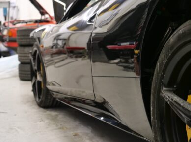 Close-up of a black Ferrari side panel and wheel