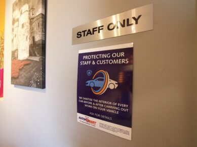 Staff only door and customer protection poster in reception