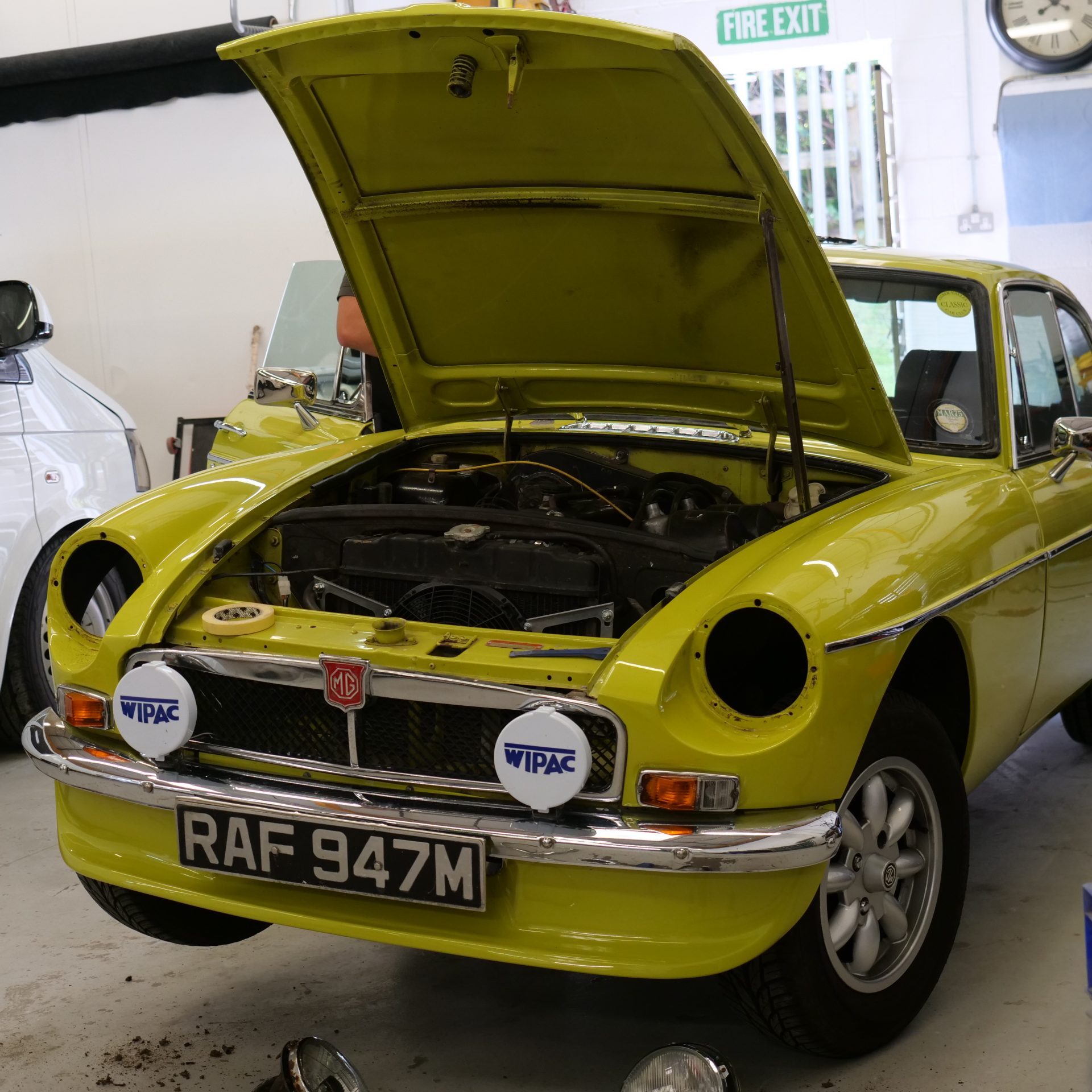 Yellow MGB GT in the Clements Bodyshop workshop