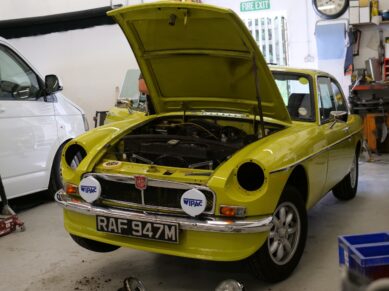 Yellow MGB GT in the Clements Bodyshop workshop